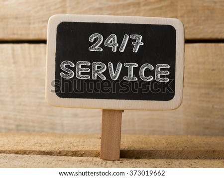 Service 247  text write on Chalkboard at wooden background 