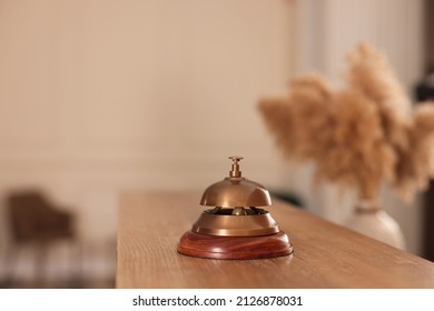 Service Bell On Wooden Reception Desk In Hotel