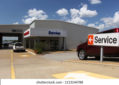 Service Department At Car Dealership Shallow DOF, Focus On Fron Service Sign 