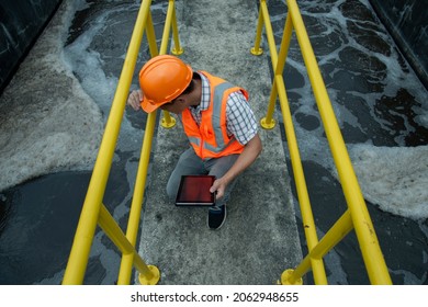 Service Engineer Checking On Waste Water Treatment Plant With Pump On Background. Worker  Working On Waste Water Plant.