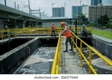 Service Engineer  Checking On Waste Water Treatment Plant With Pump On Background. Worker  Working On Waste Water Plant.