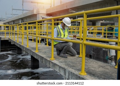 Service Engineer  Checking On Waste Water Treatment Plant With Pump On Background. Worker  Working On Waste Water Plant.