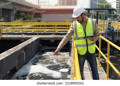 Service Engineer  Checking On Waste Water Treatment Plant With Pump On Background. Worker  Working On Waste Water Plant.