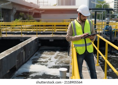 Service Engineer  Checking On Waste Water Treatment Plant With Pump On Background. Worker  Working On Waste Water Plant.