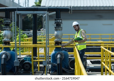 Service Engineer  Checking On Waste Water Treatment Plant With Pump On Background. Worker  Working On Waste Water Plant.