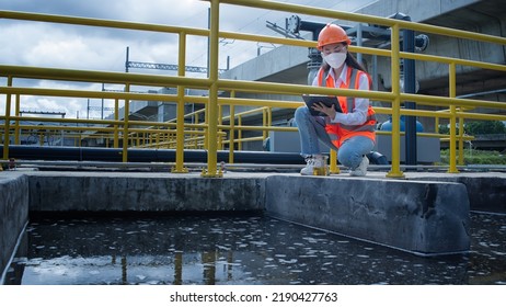 Service Engineer  Checking On Waste Water Treatment Plant With Pump On Background. Worker  Working On Waste Water Plant.