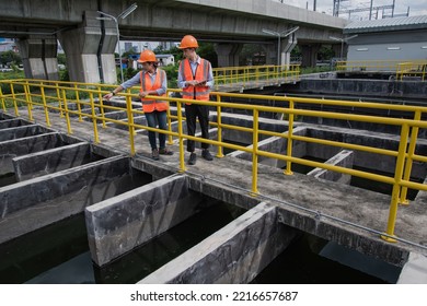 Service Engineer  Checking On Waste Water Treatment Plant With Pump On Background. Worker  Working On Waste Water Plant.