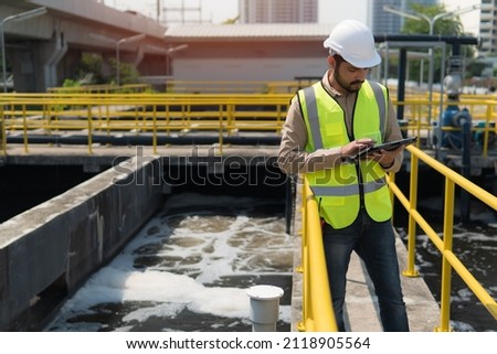 service engineer  checking on waste water treatment plant with pump on background. worker  working on Waste water plant.