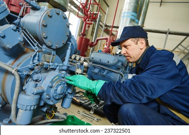 Service Engineer Worker At Industrial Compressor Refrigeration Station Repairing And Adjusting Equipment At Manufacturing Factory