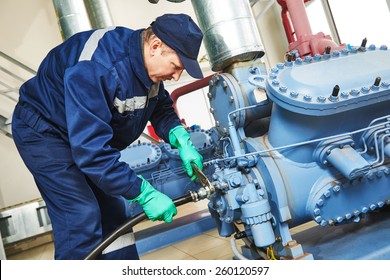 Service Engineer Worker At Industrial Compressor Refrigeration Station Repairing And Adjusting Equipment At Manufacturing Factory