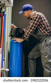 Service man adjusting house heating system