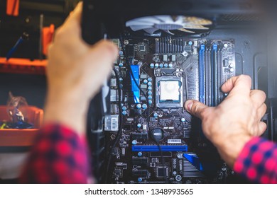 IT service and man fixing a PC in a workshop. Professional worker. Modern technology.