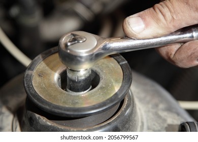 Service Man Hand Screws The Shock Absorber Nut With Wrench Close Up -   McPherson Type Car Suspension Strut Repair Maintenance