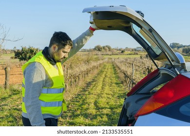 Service Man Opening Trunk Of Car