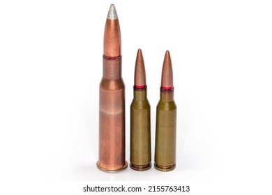 Service Rifle Cartridges Of The Different Caliber Stand On A White Background, Close-up 
