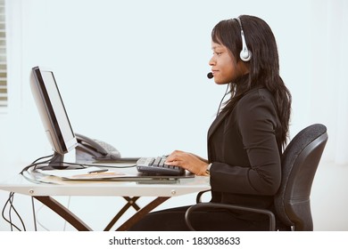 Service: Side View Of Woman At Modern Desk Set Up