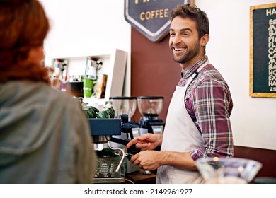 Service With Smile. Shot Of A Young Woman Ordering Coffee In A Cafe.