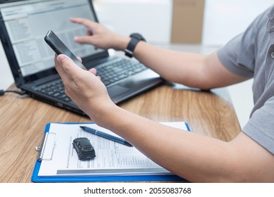 Service Staff Use Smartphone Check Details About Car Repairs Compared To The Data In Laptop To Estimate The Cost Of Car Repairs In Office Car Service Center