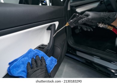 Service Station Worker Using Pneumatic Tool On Automotive Interior Surface