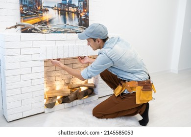 Service Technician Repairing A Fireplace In A Home