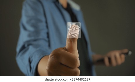 Service users lift their thumbs up and scan their fingers to enter the identity verification system. There is a fingerprint scanning light icon. Security concept for accessing technology systems. - Shutterstock ID 2394492137