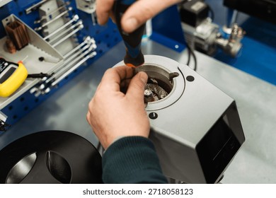Service worker disassembles professional coffee grinder for maintenance and repair