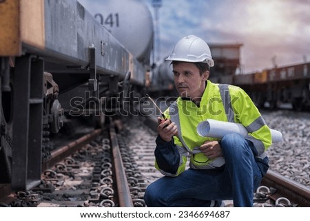 service worker with freight train oil transport on background. Portrait engineer on railway.