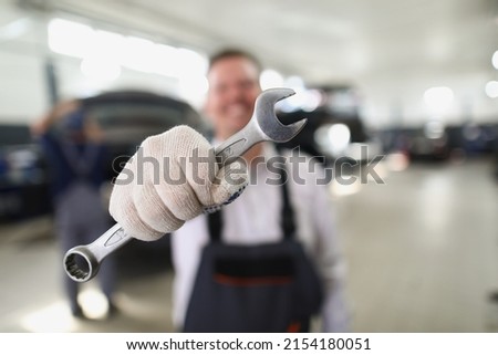 Service worker hold wrench equipment, metal tool to fix vehicle