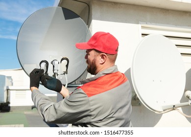 Service Worker Installing And Fitting Satellite Antenna Dish For Cable TV