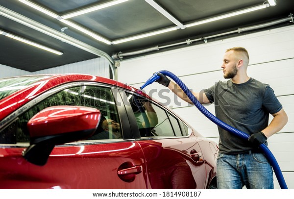 Service worker makes automatic drying of the car\
after washing.