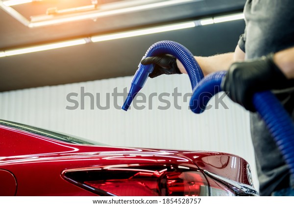 Service worker makes automatic drying of the car\
after washing.