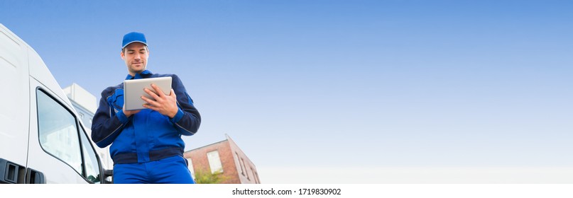 Service Worker Near Delivery Truck Using Tablet Technology