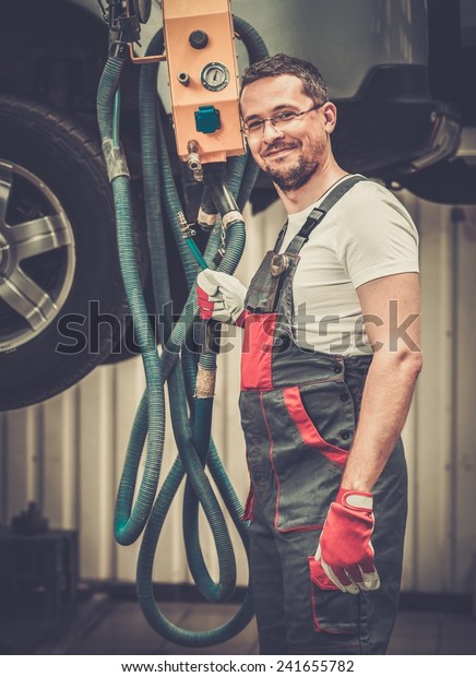 Serviceman in a car\
workshop