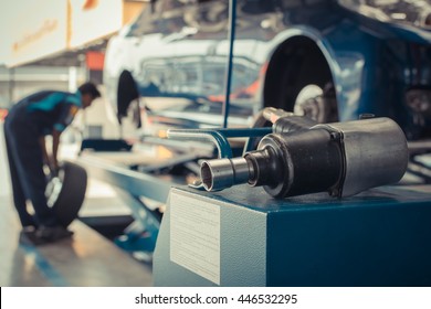 Serviceman checking suspension in a car at garage , process in vintage style - Powered by Shutterstock