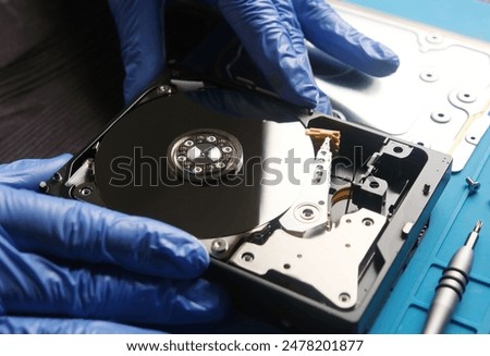 Serviceman repairs hdd data disk in service center