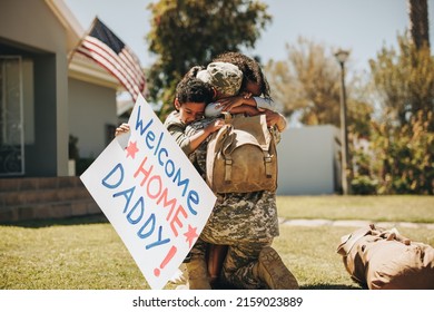 Serviceman reuniting with his family after returning home from the army. American soldier embracing wife and children outdoors. Military man receiving a warm welcome from his family. - Powered by Shutterstock