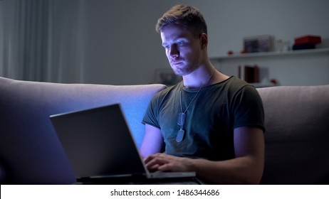 Serviceman searching job on laptop at home, adapting to civilian life after army - Powered by Shutterstock