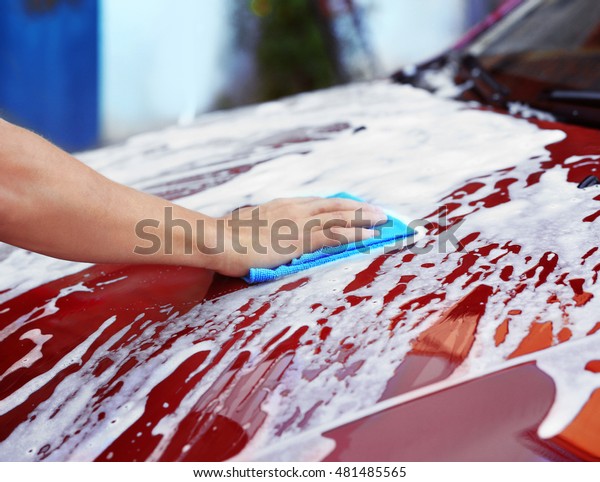 Serviceman washing a
car