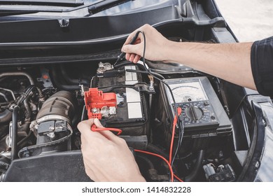 Services Car Engine Machine Concept, Automobile Mechanic Repairman Hands Checking A Car Engine Automotive Workshop With Digital Multimeter Testing Battery, Car Service And Maintenance.