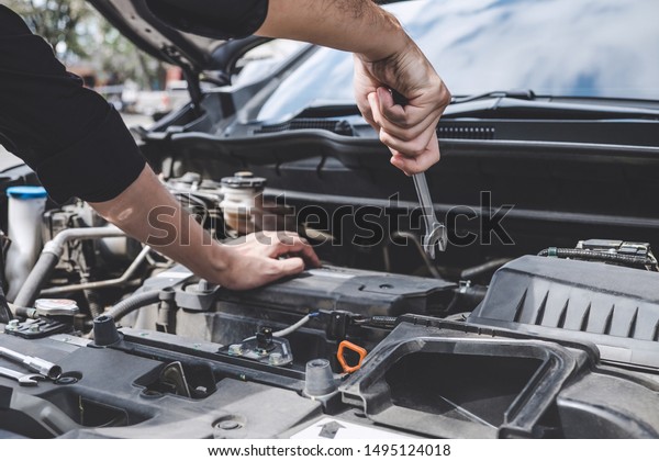 Services car engine machine\
concept, Automobile mechanic repairman hands repairing a car engine\
automotive workshop with a wrench, car service and\
maintenance.