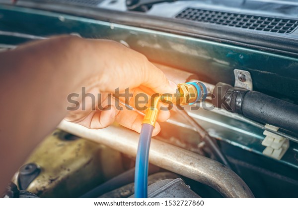 Servicing car air conditioner. Service station.\
Car repair.