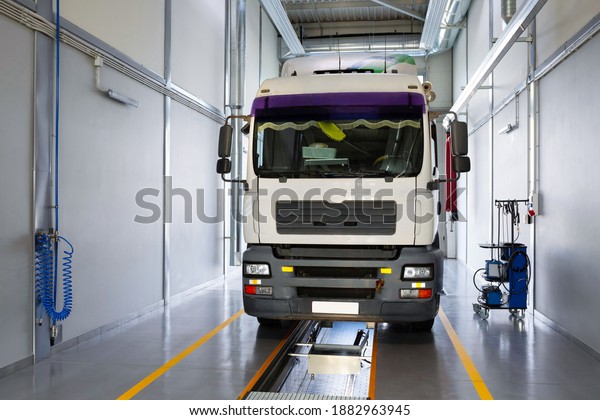 Servicing and repairing trucks\
in a large garage. Truck in a car service for diagnostics. Car\
service