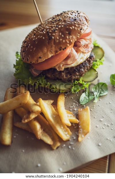 Serving Beef Burger with Fries in Restaurant. BBQ\
Beef Burger in Sezame\
Bun.