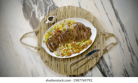 Serving A Beef Steak Plate With Sauce And Salad, Top View