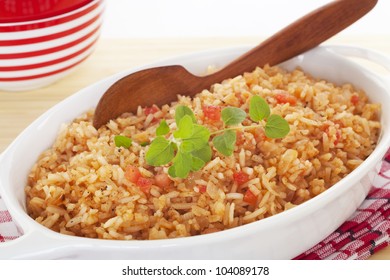 A Serving Bowl Full Of Spanish Rice, A Perfect Accompaniment For Chili. It's Flavoured With Onion, Garlic, Chicken Stock, Tomato And Oregano.