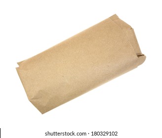 A serving of butchers meat wrapped in brown paper.