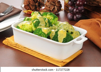 A Serving Dish Of Broccoli With Cheddar Cheese Sauce