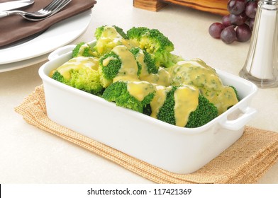 A Serving Dish Of Broccoli With Cheddar Cheese Sauce