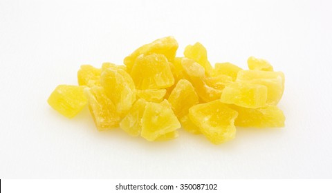 A Serving Of Dried Sugared Pineapple Chunks On A Plastic Cutting Board.