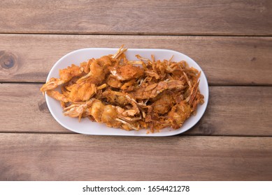 A Serving Of Fried Baby Crab,a Traditional And Famous Street Found Isolated Over Wooden/white Background.